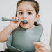 Boy using weaning spoon, giraffe 2 in 1 fork and spoon in grey