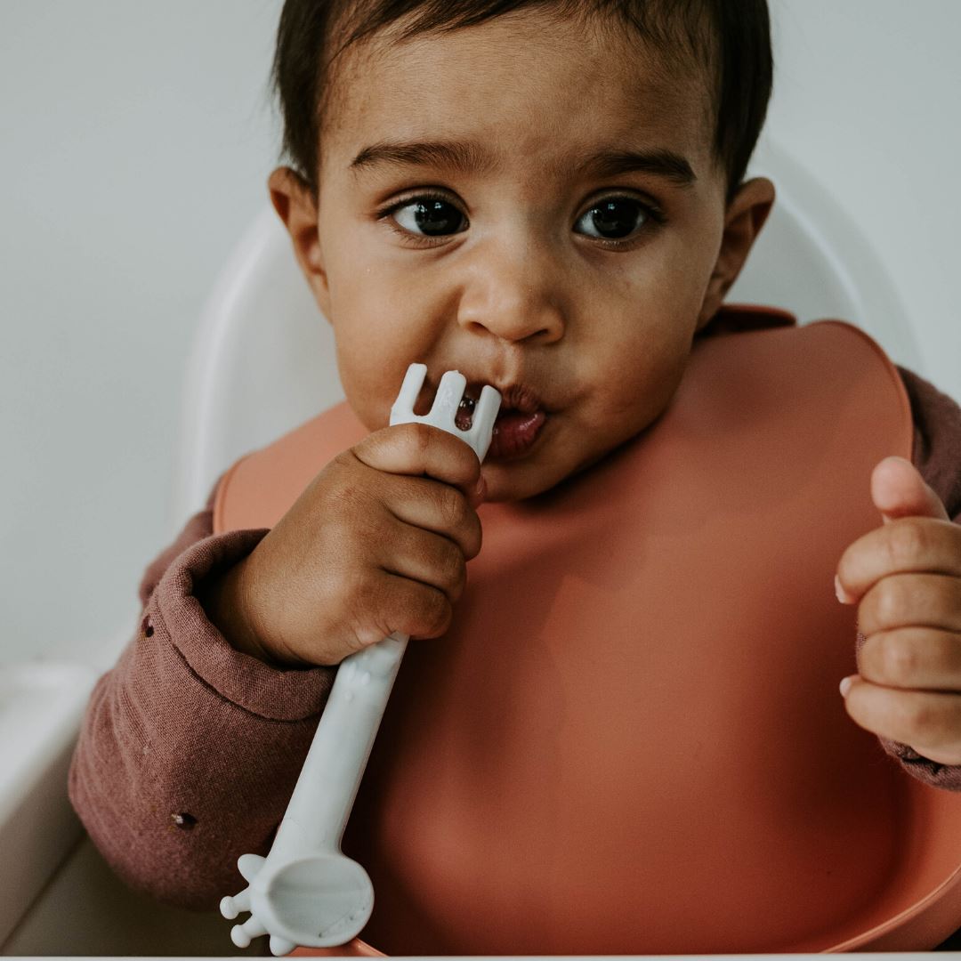 Baby using Boo Chew weaning spoon, 2 in 1 fork and spoon in marble