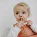 Toddler using 2 in 1 Fork and Spoon, fork end, weaning spoon in rust